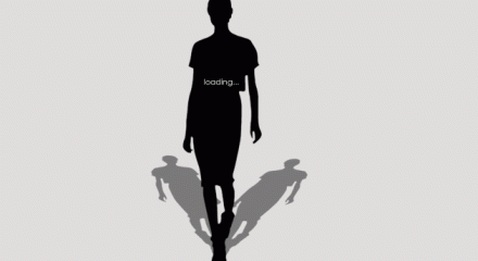 Silhouette of model on runnway with loading... written on her