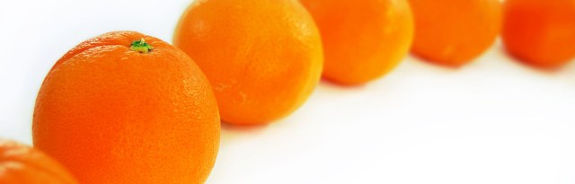 Peeling-oranges-banner Row of oranges, waiting to be peeled